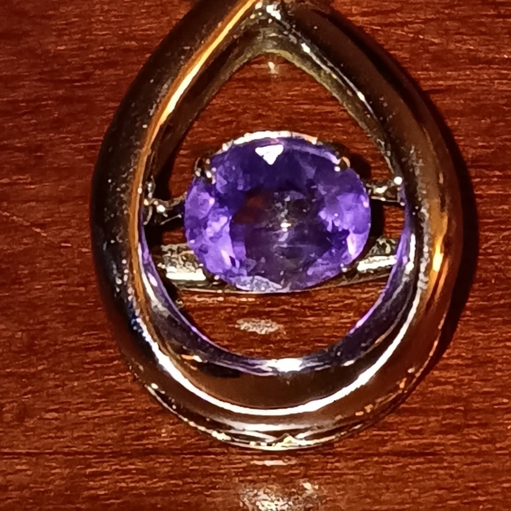 Small silver pendant with spinning stone